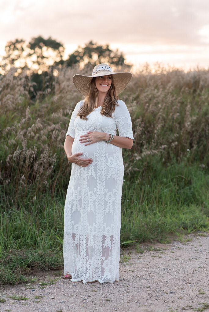 Expecting mom in white maternity dress, wearing hat at maternity session | Sharon Leger Photography | CT Newborn & Family Photographer | Canton, Connecticut