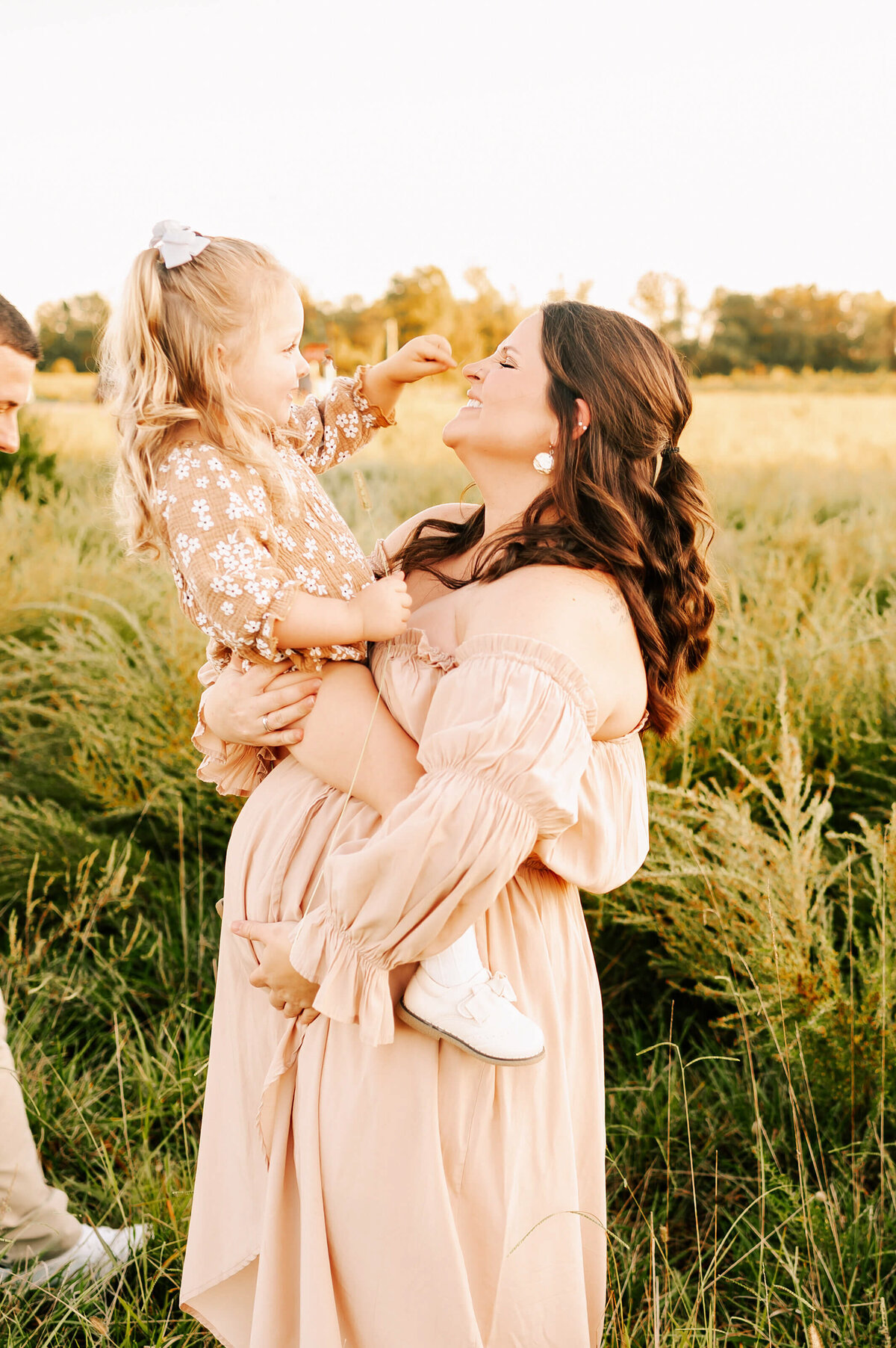 outdoor maternity photo in Springfield MO of pregnant mom holding toddler