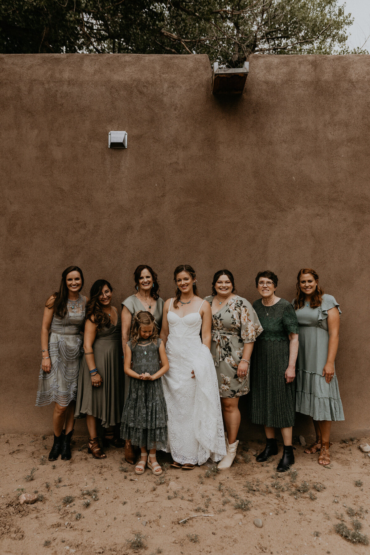 bride and bridesmaids together wearing green dresses