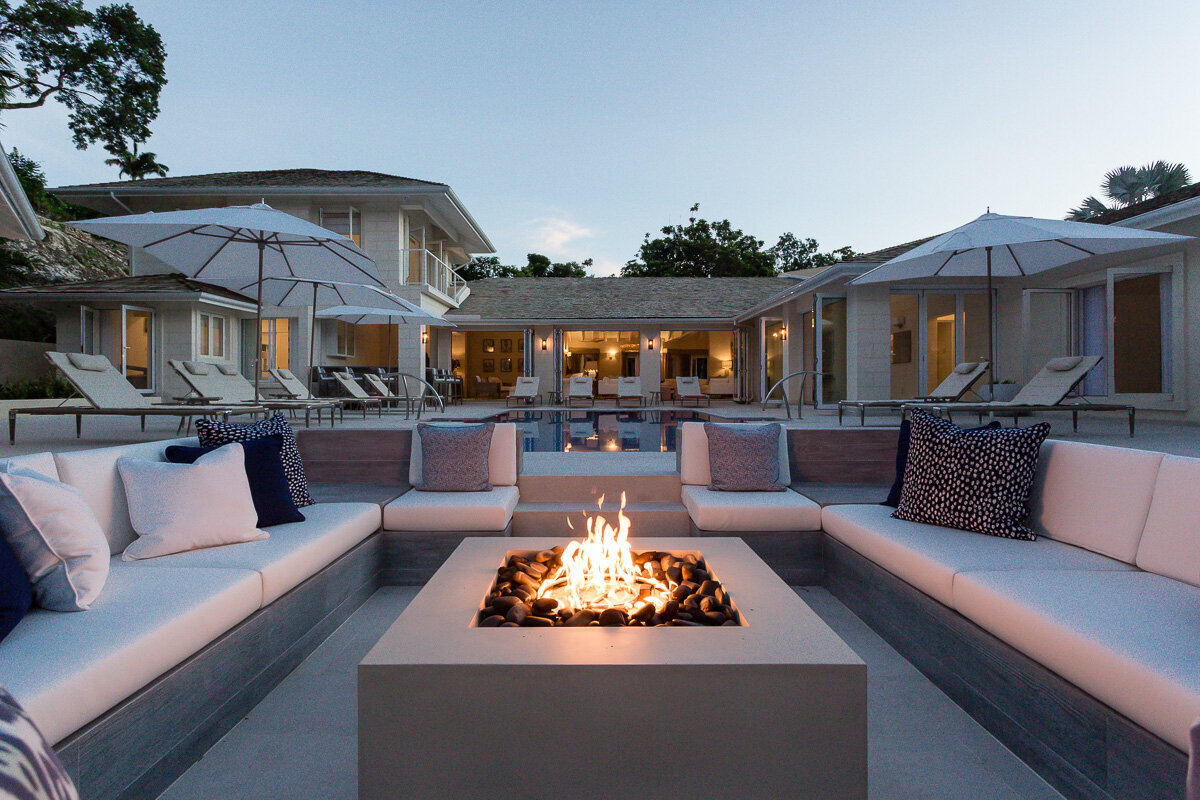 View from the firepit to the main villa which was a recent interior design project in Barbados