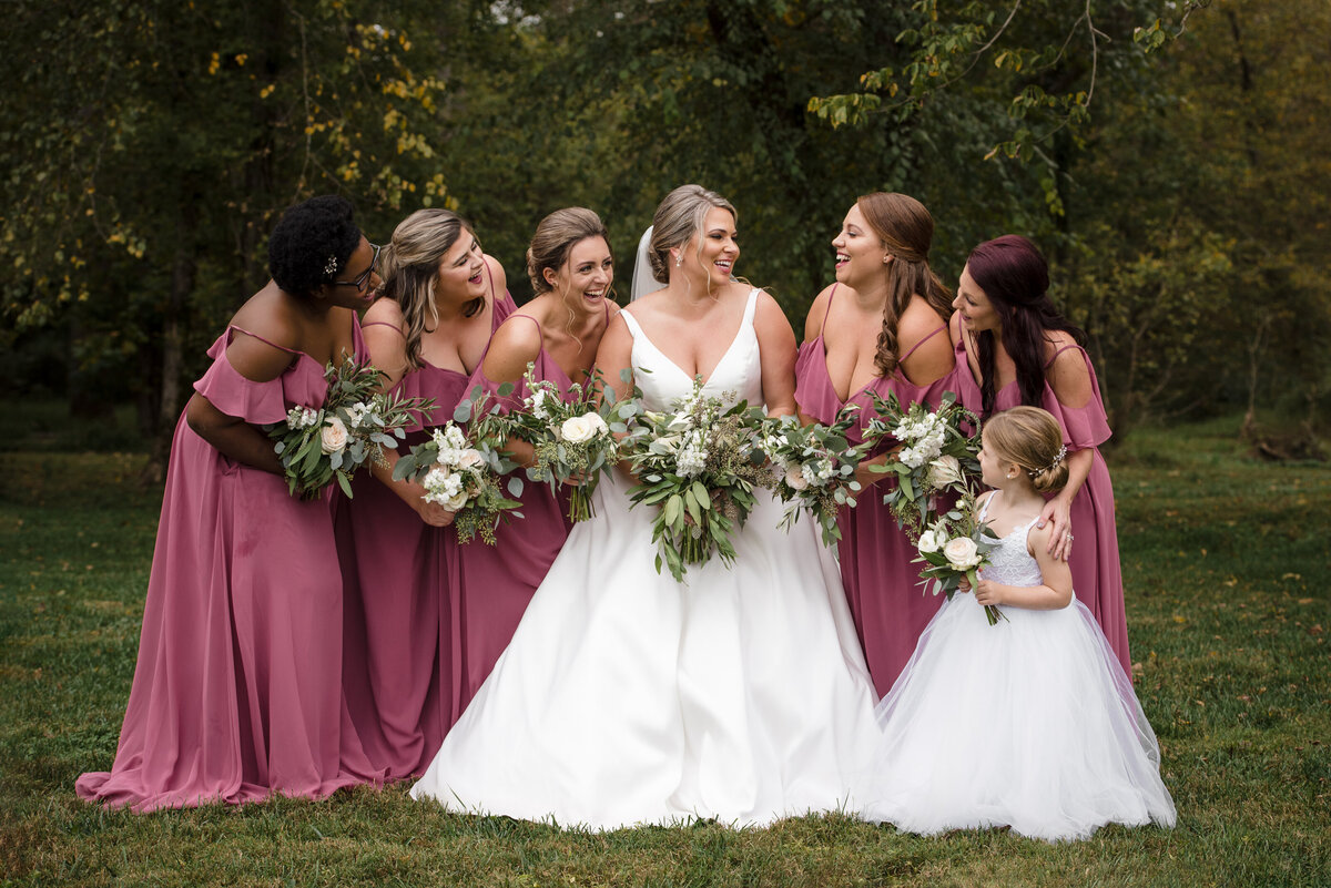 Bride-and-bridesmaids-smiling-and-laughing-outdoors-at-the-Providence-Cotton-Mill