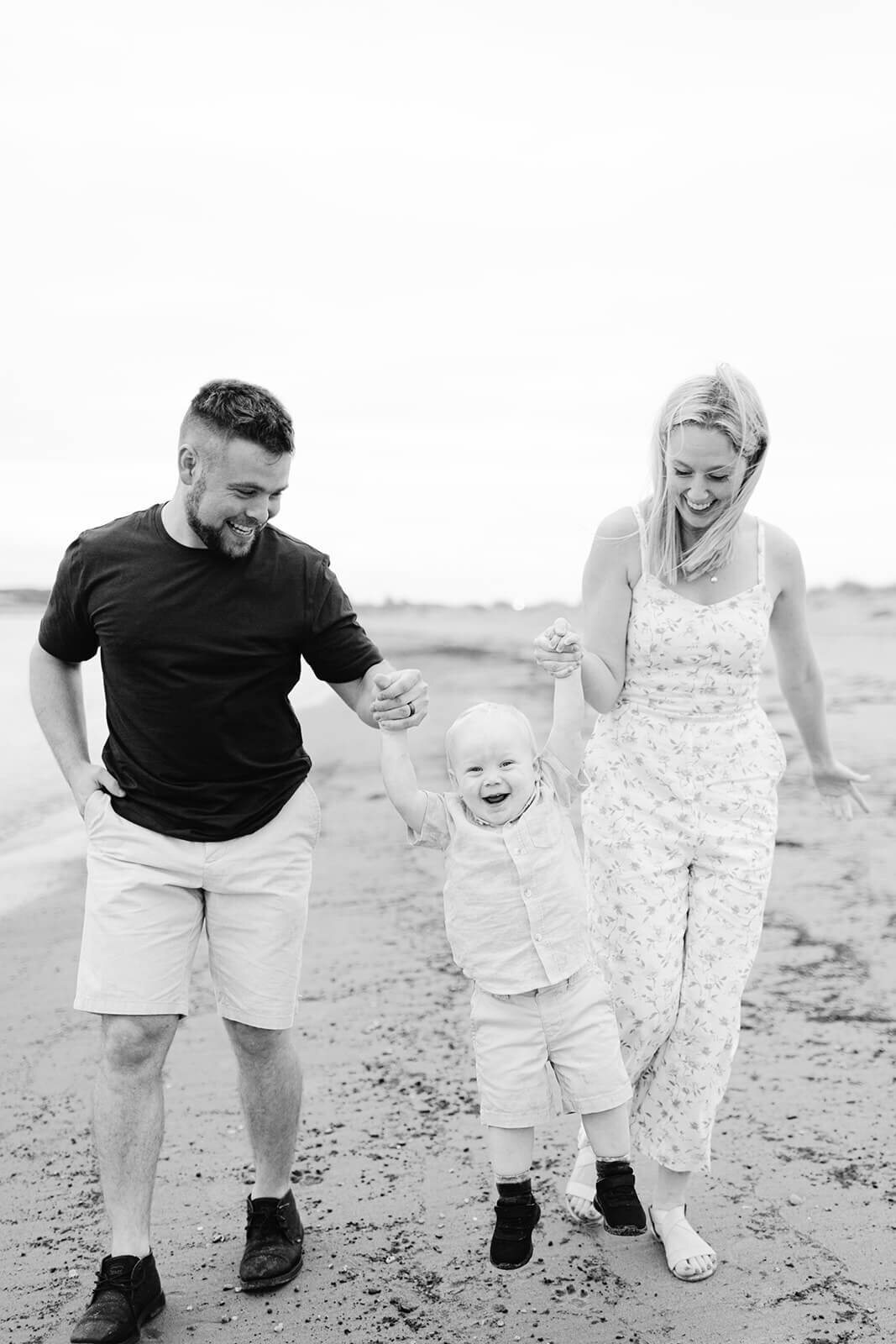 playful-family-with-kid-on-the-beach