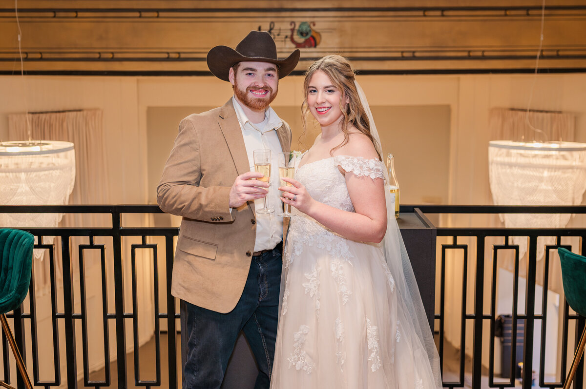 A married couple enjoying cocktails at their wedding reception at The Orpheum by Raleigh wedding photographer, JoLynn Photography