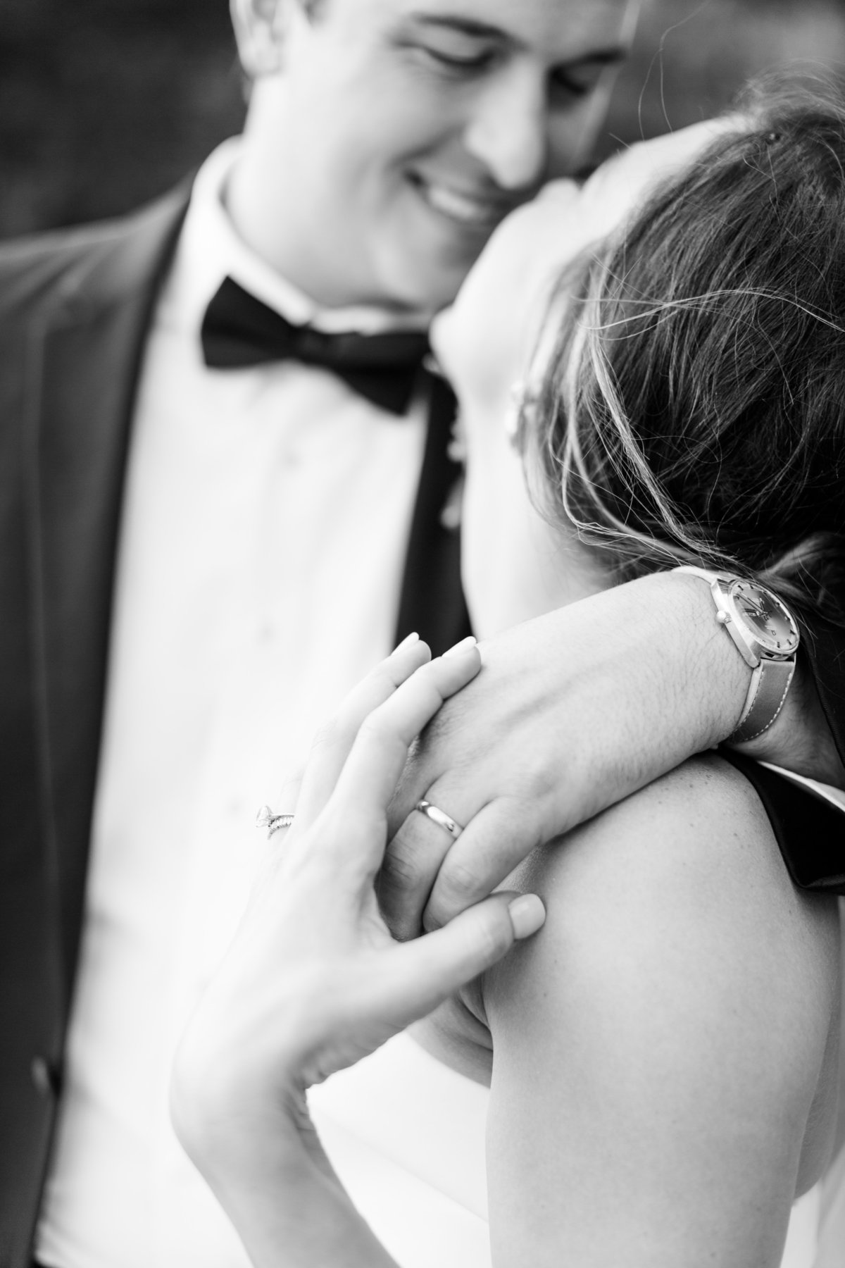Bride and groom embracing in black and white
