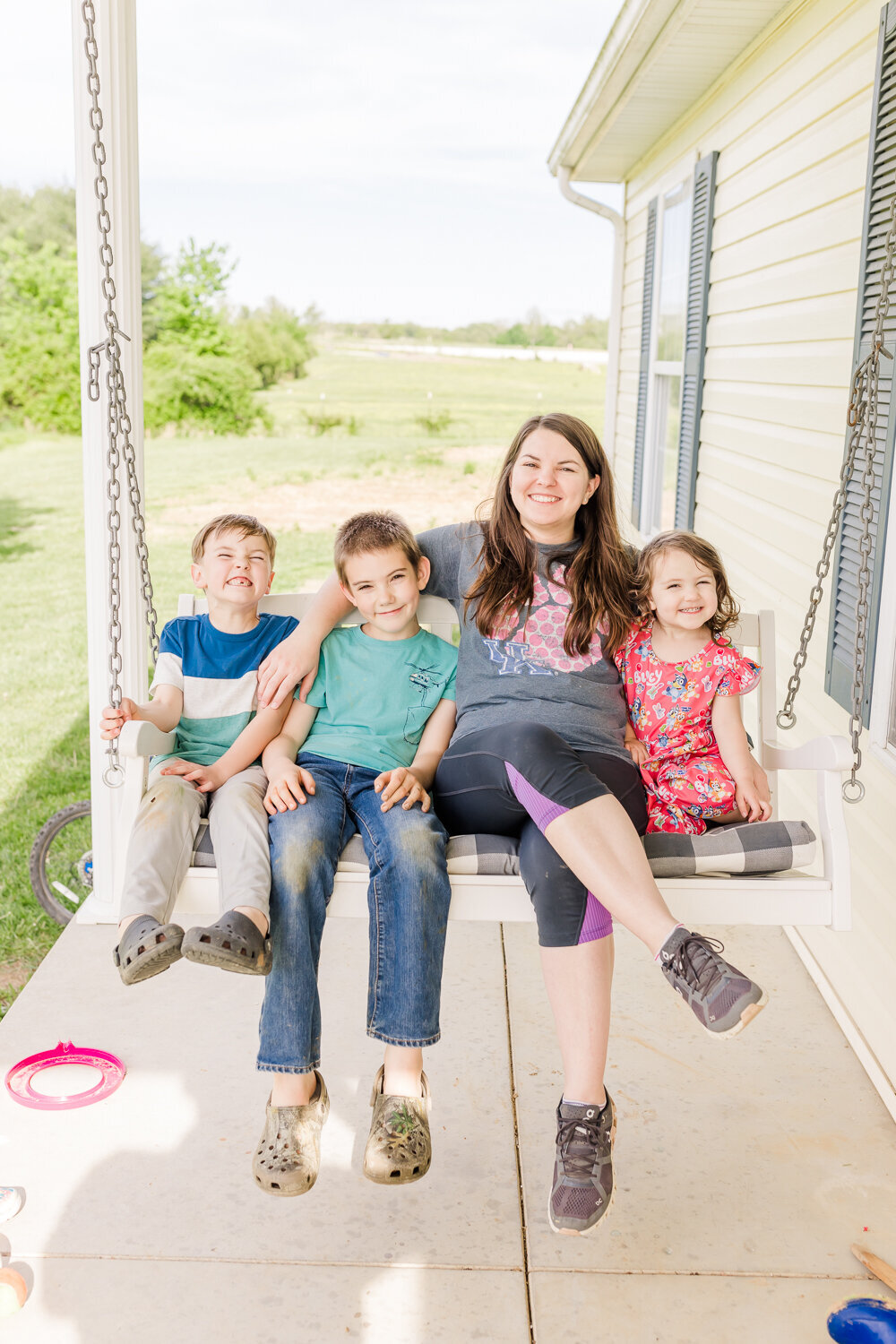 myself with my three kids sitting on the porch swing
