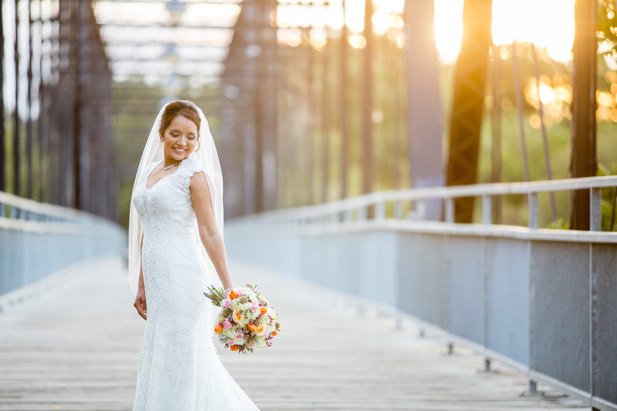bride standing on bridge at Milltown Historic District Wedding Venue by San Antonio Wedding photographer Expose The Heart