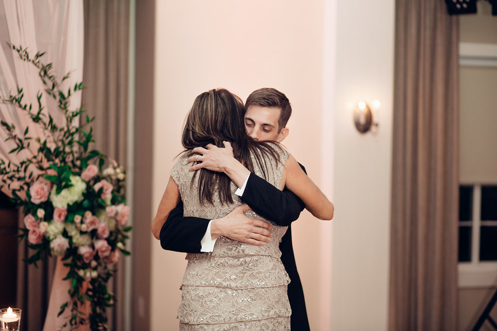 Wedding Photograph Of Groom Hugging Woman In Light Brown Dress Los Angeles