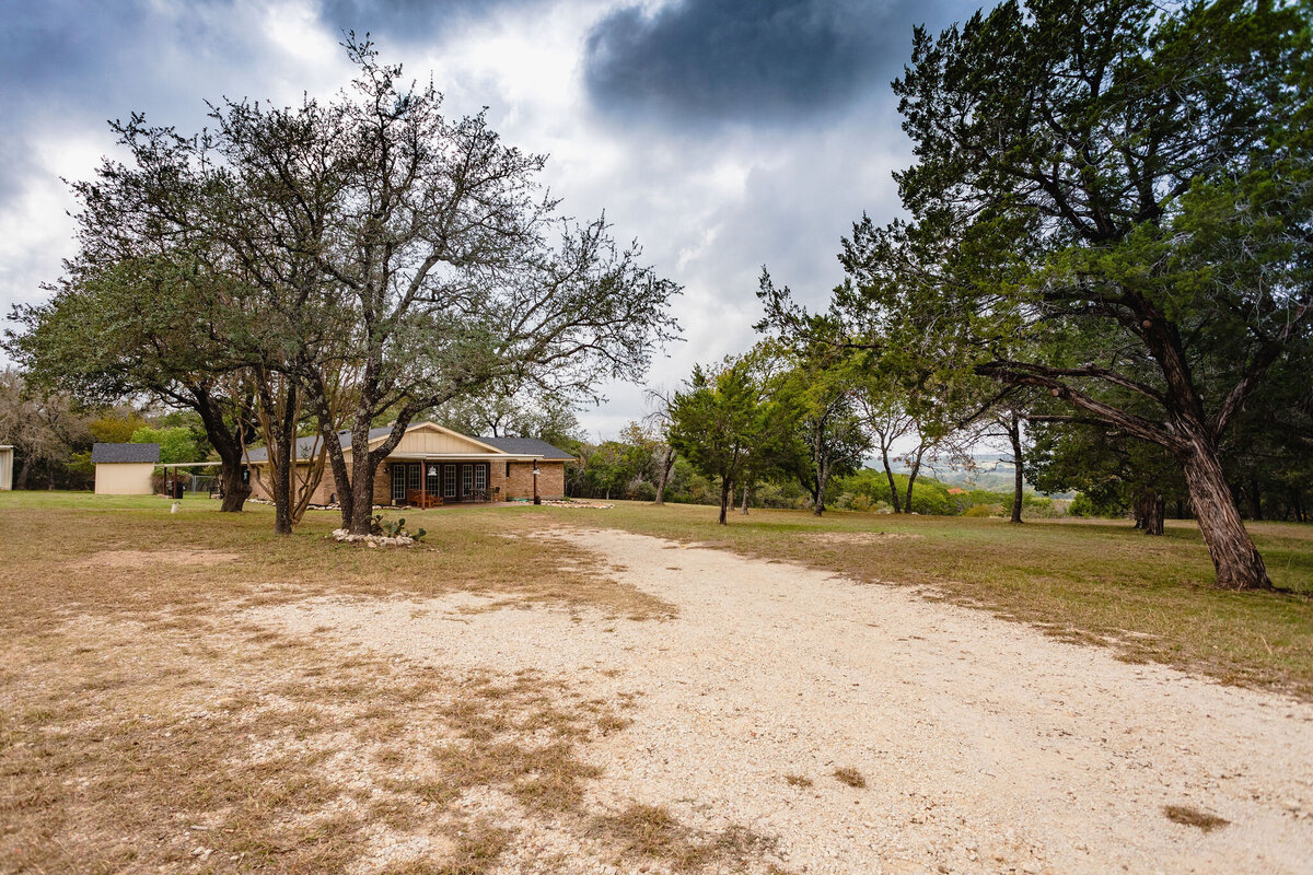 Large driveway and side view of this three-bedroom, two-bathroom ranch house for 7 with incredible hiking, wildlife and views.