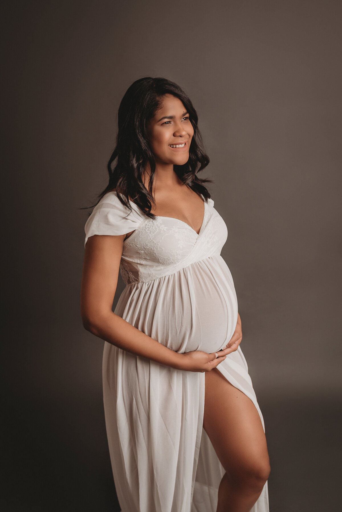Pregnant woman wearing white sheer dress