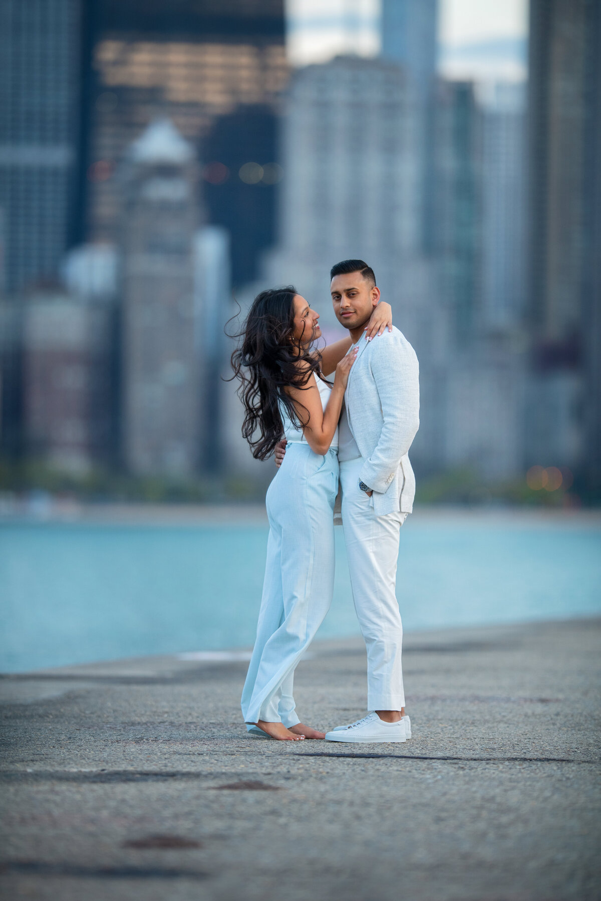 Stylish couple posing during windy day in Chicago