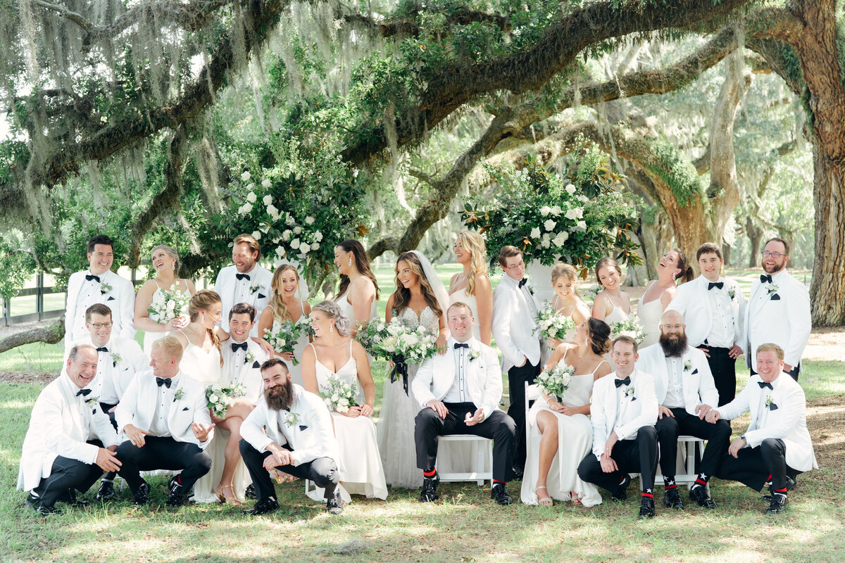 Full bridal party under the trees at Boone Hall. Spanish moss and live oak trees.