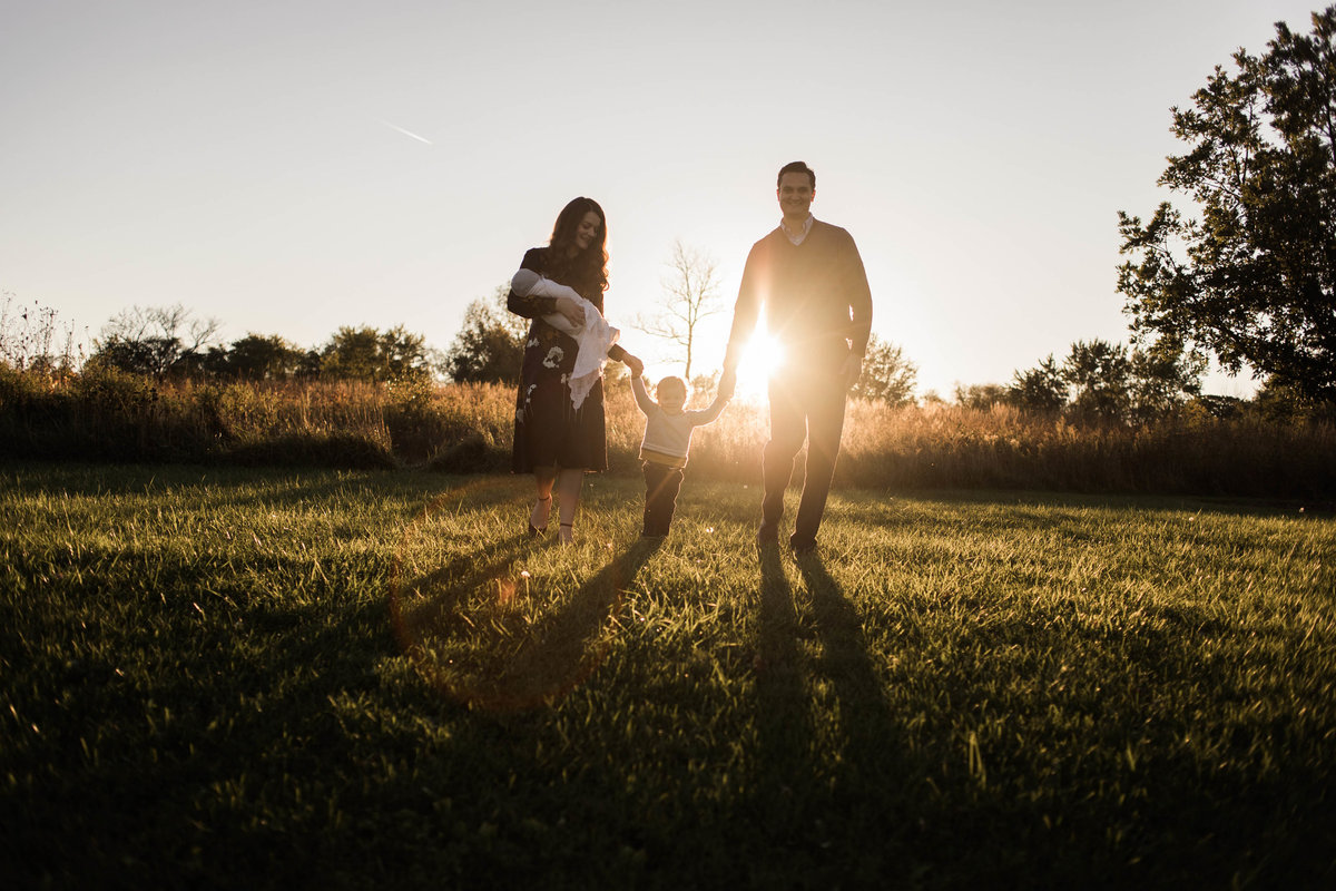 Family of four walking during a sunset session with Elle Baker Photography
