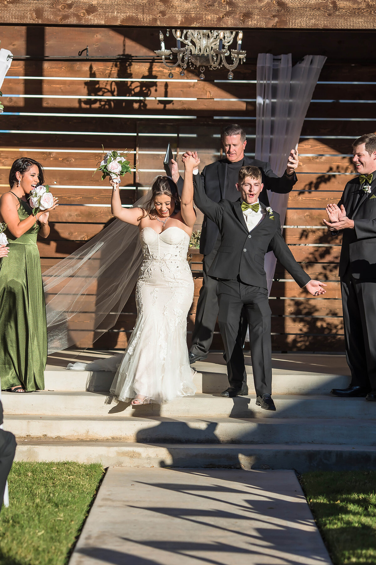Couple cheering at the end of an outdoor ceremony at the SoDA District in Abilene TX