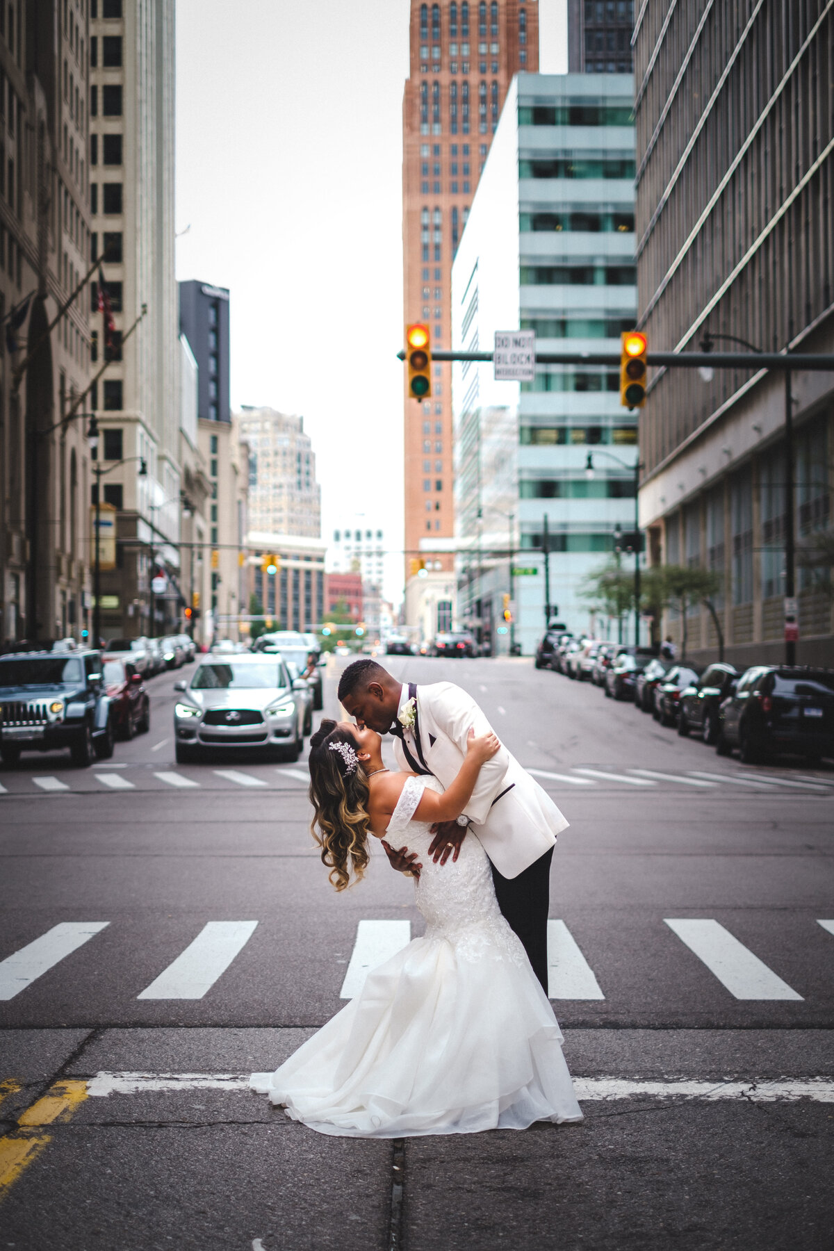 Bride and groom kissing in the street
