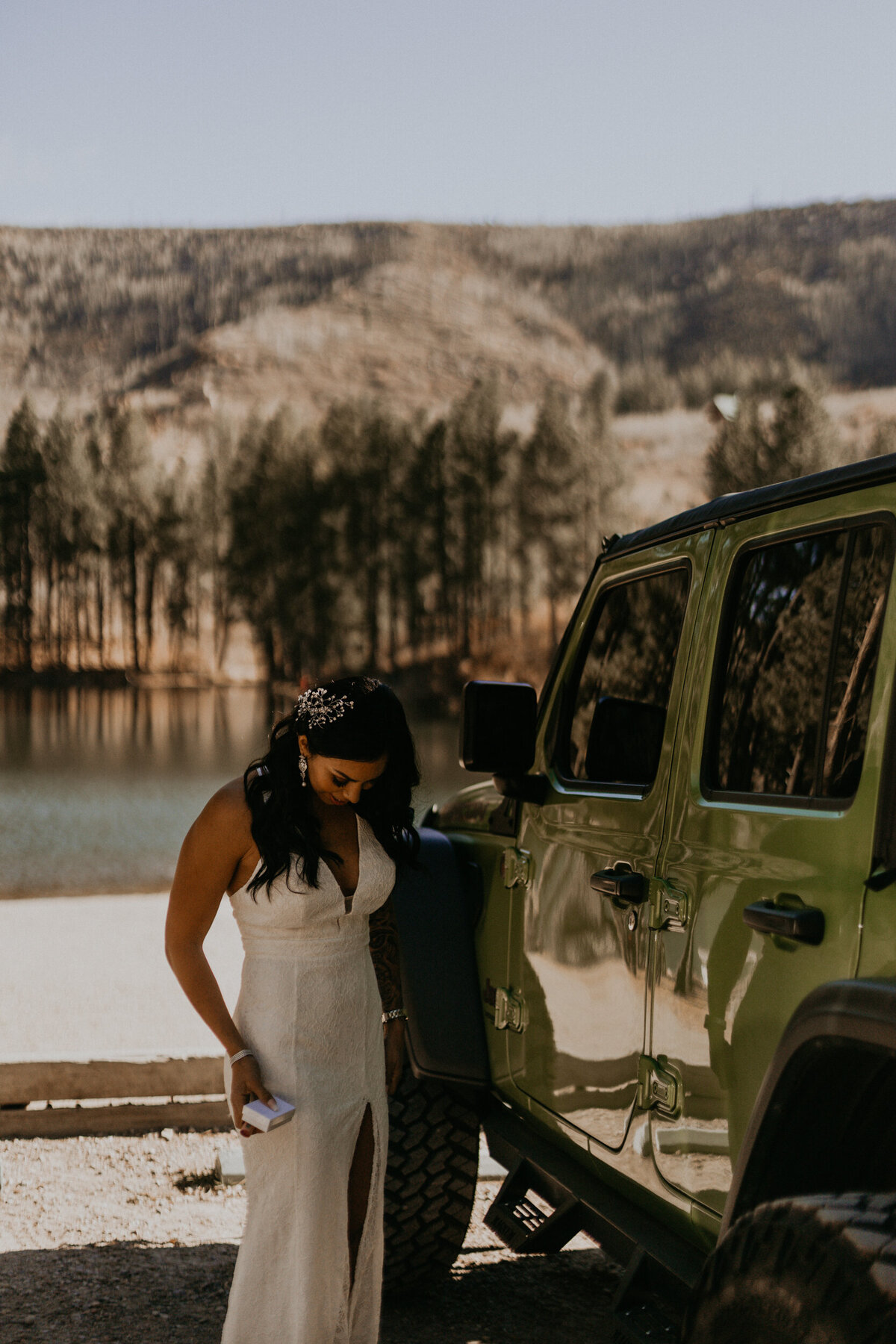 bride getting ready outside of her jeep wrangler