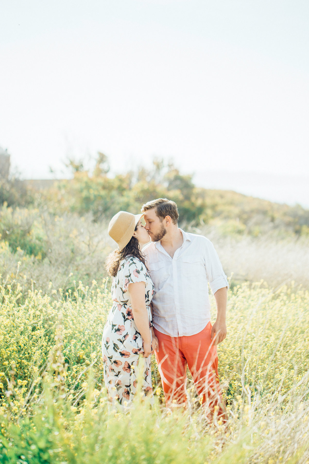 Engagement Photograph Of  Man And Woman Kissing In The Middle Of Meadow Los Angeles