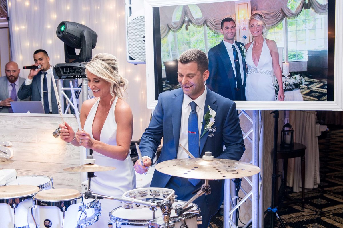 Bride and groom playing the drums at Giorgio's Baiting Hollow