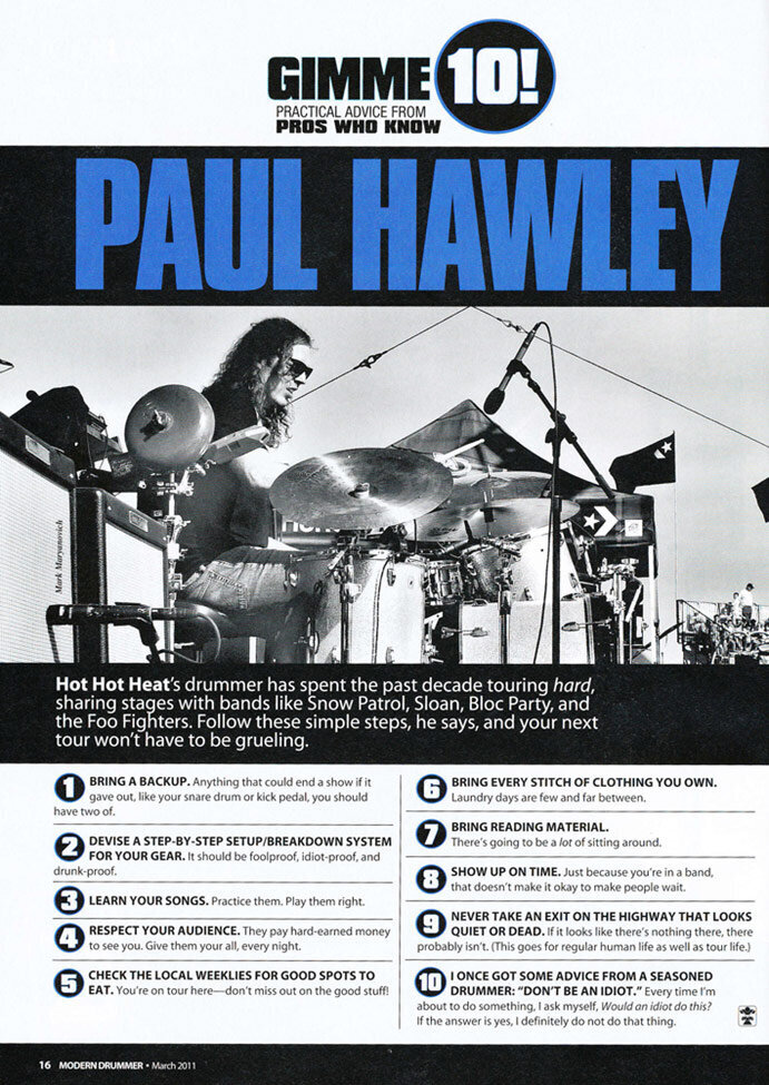 Magazine Feature Modern Drummer Paul Hawley sitting behind drum set on stage