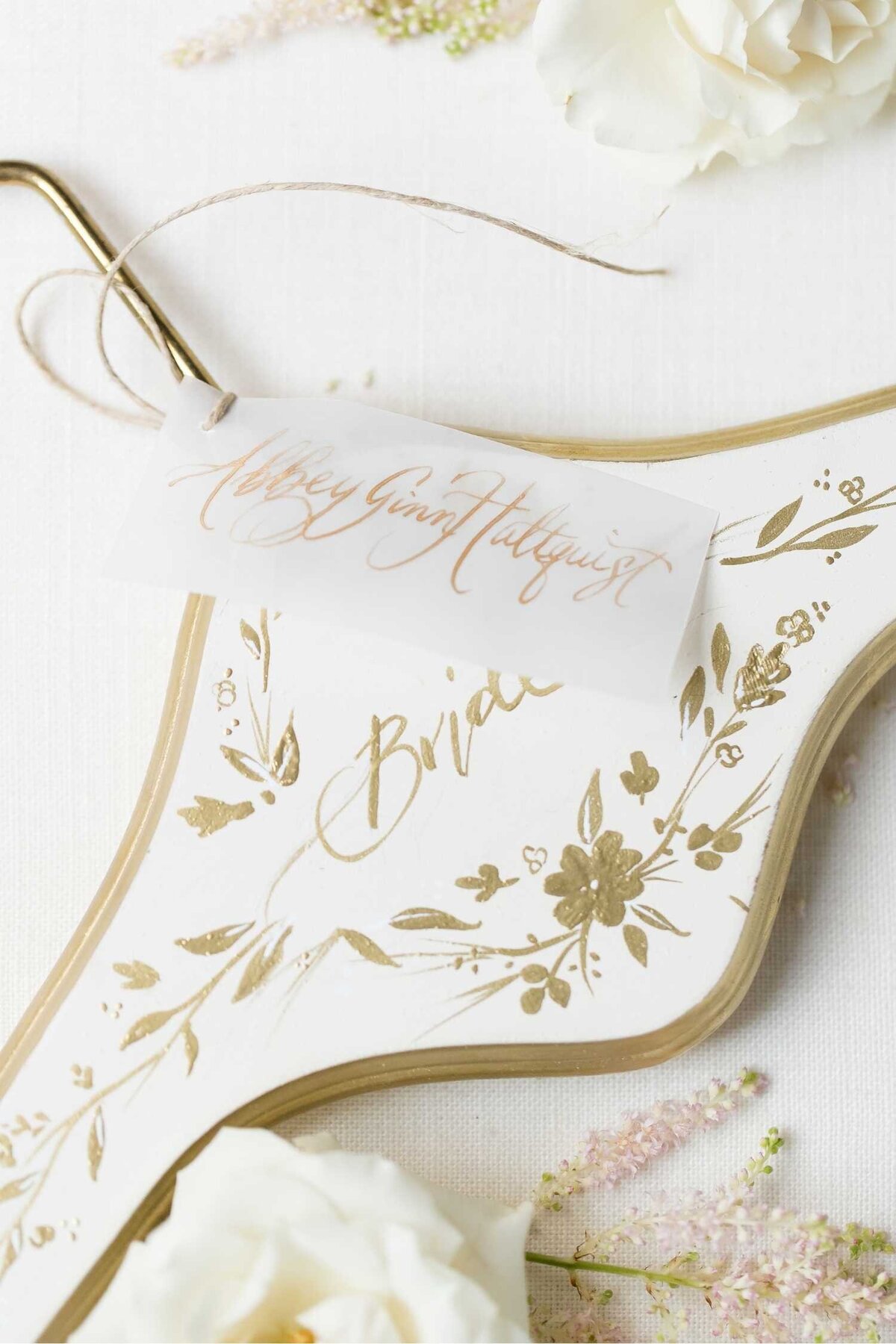 Hand Painted Gold and White Bridal Wedding Dress Hanger with Calligraphy tag at Luxury Chicago Outdoor Historic Wedding Venue  Ambassador Hotel