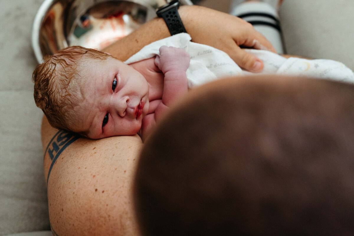 newborn-making-eye-contact-with-dad
