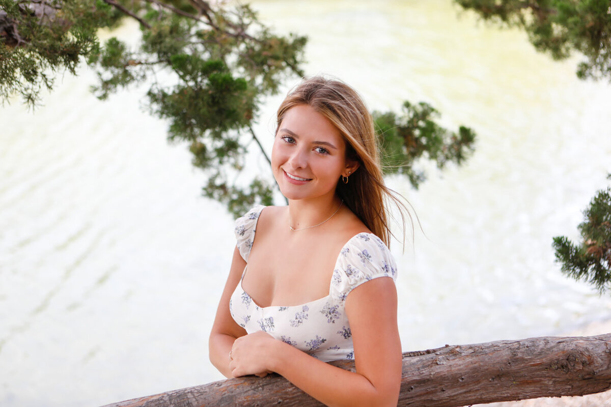 Image of senior girl in front of lake, natural light