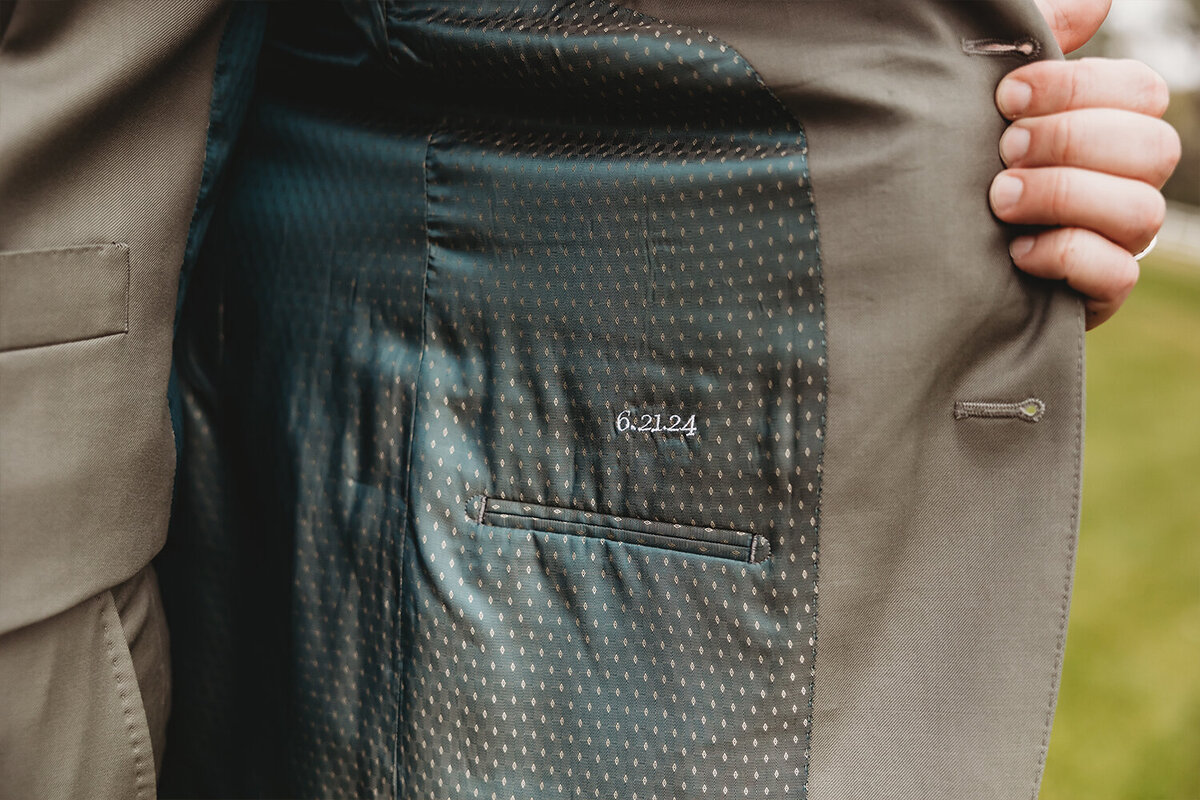 Inside of groom suit with wedding date embroidered for a sage green mountain wedding.