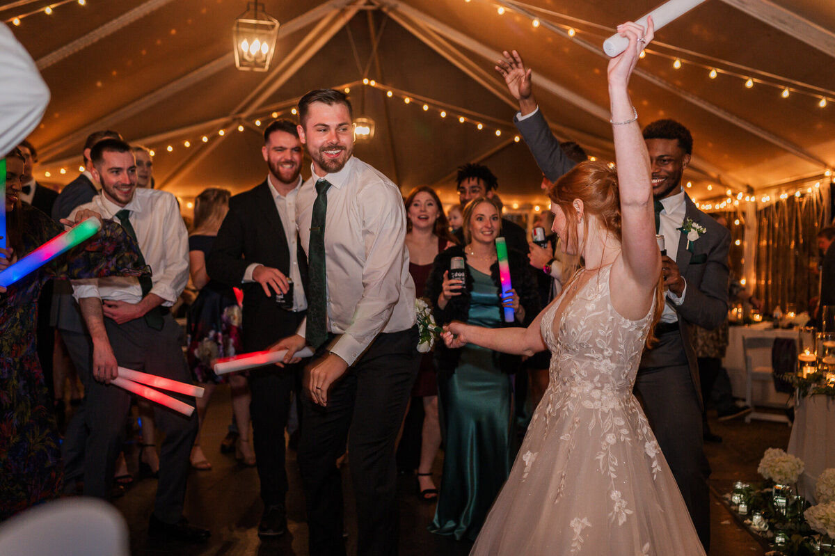 A bride and groom dancing with glow sticks at their wedding reception in Savannah by JoLynn Photography, a North Carolina wedding photographer