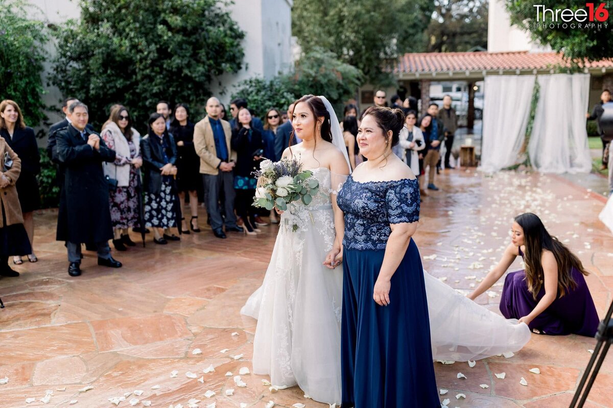 Mother of the Bride escorts her daughter down the aisle