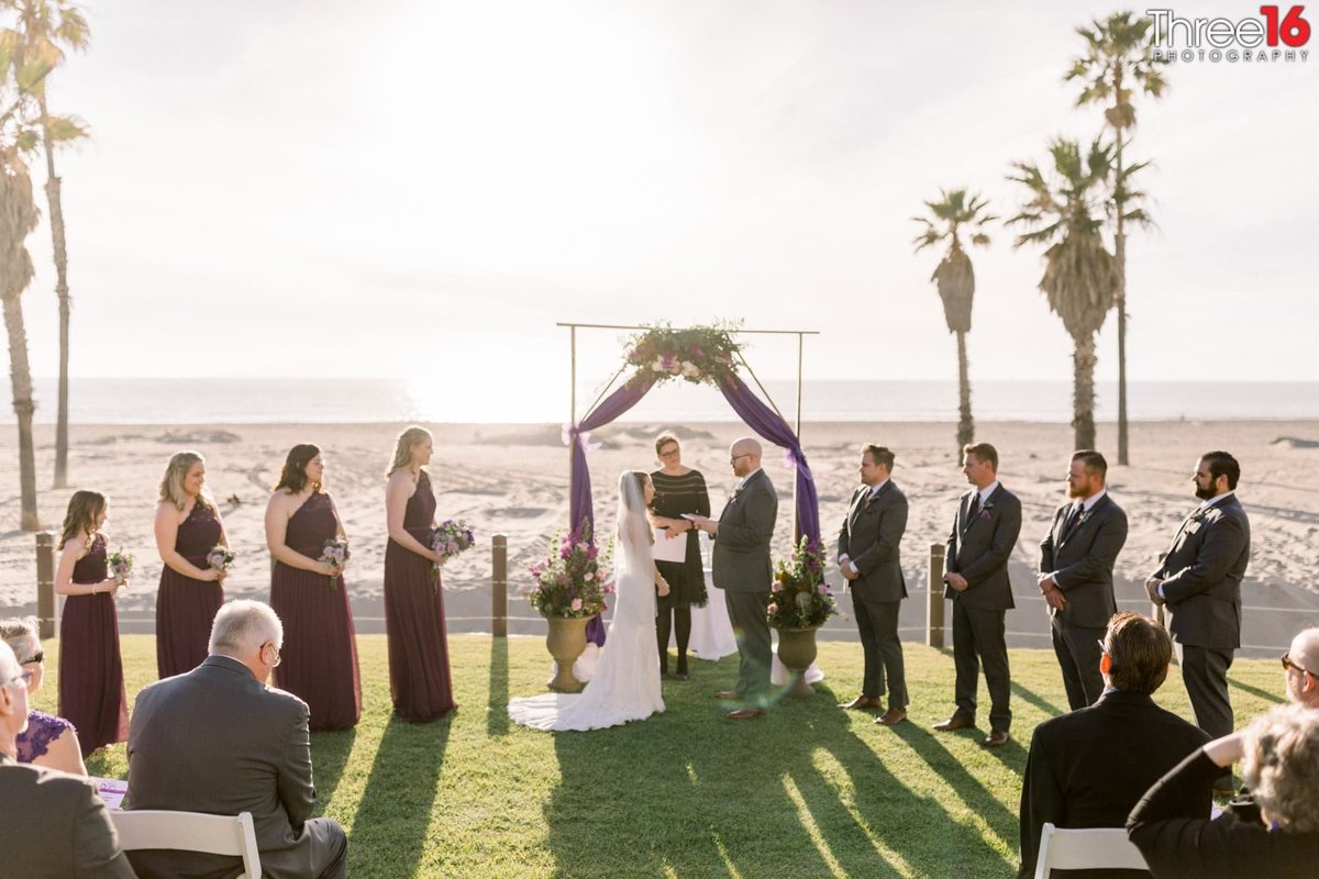 Groom reads his vows to his Bride during outdoor wedding ceremony at the Mandalay Beach Resort in Oxnard