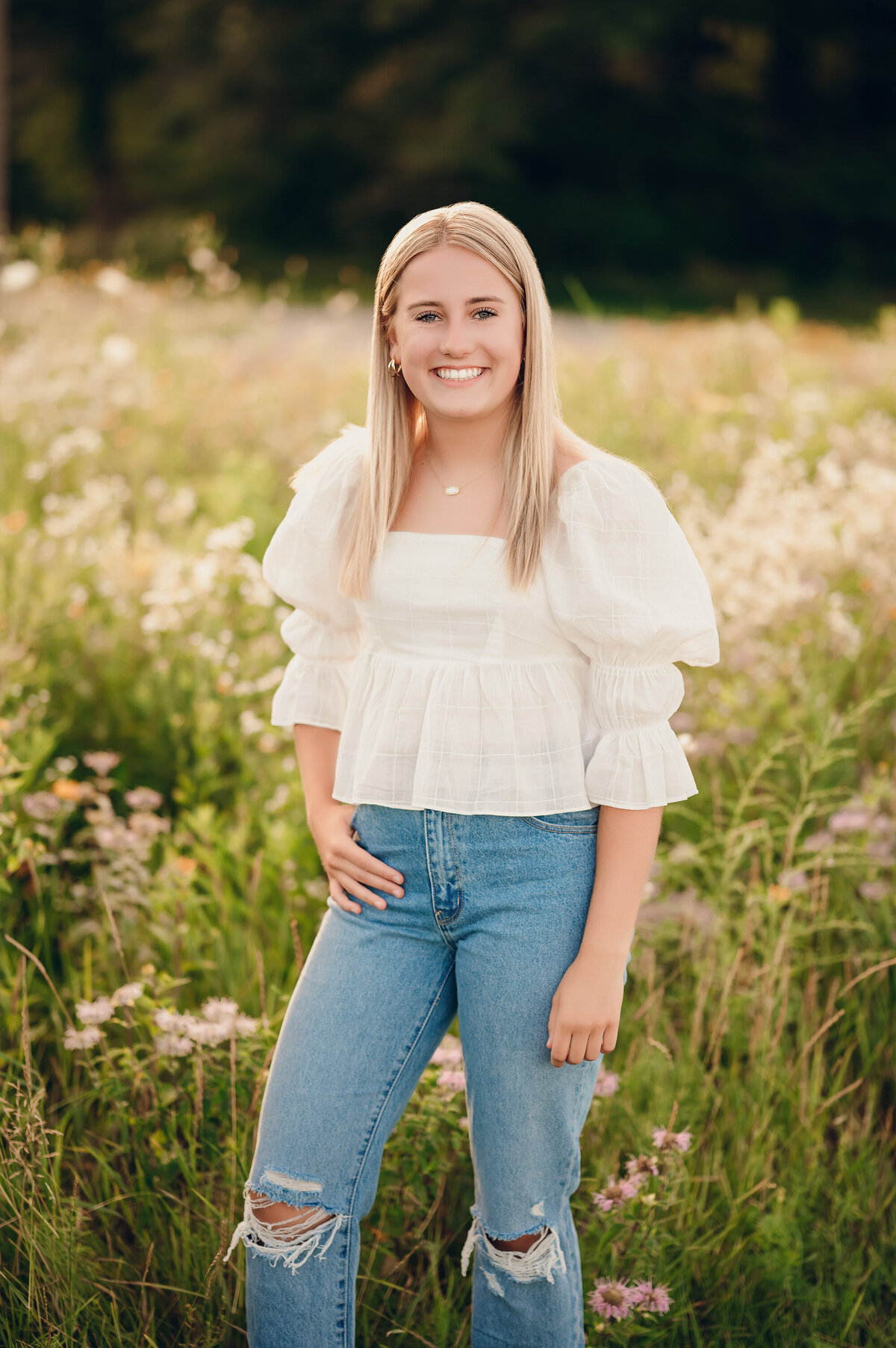 A Waukesha North High School student stands in field of wildflowers at Frame Park during her senior photoshoot.