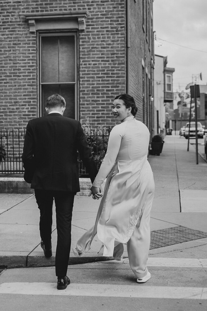 bride and groom crossing the street together