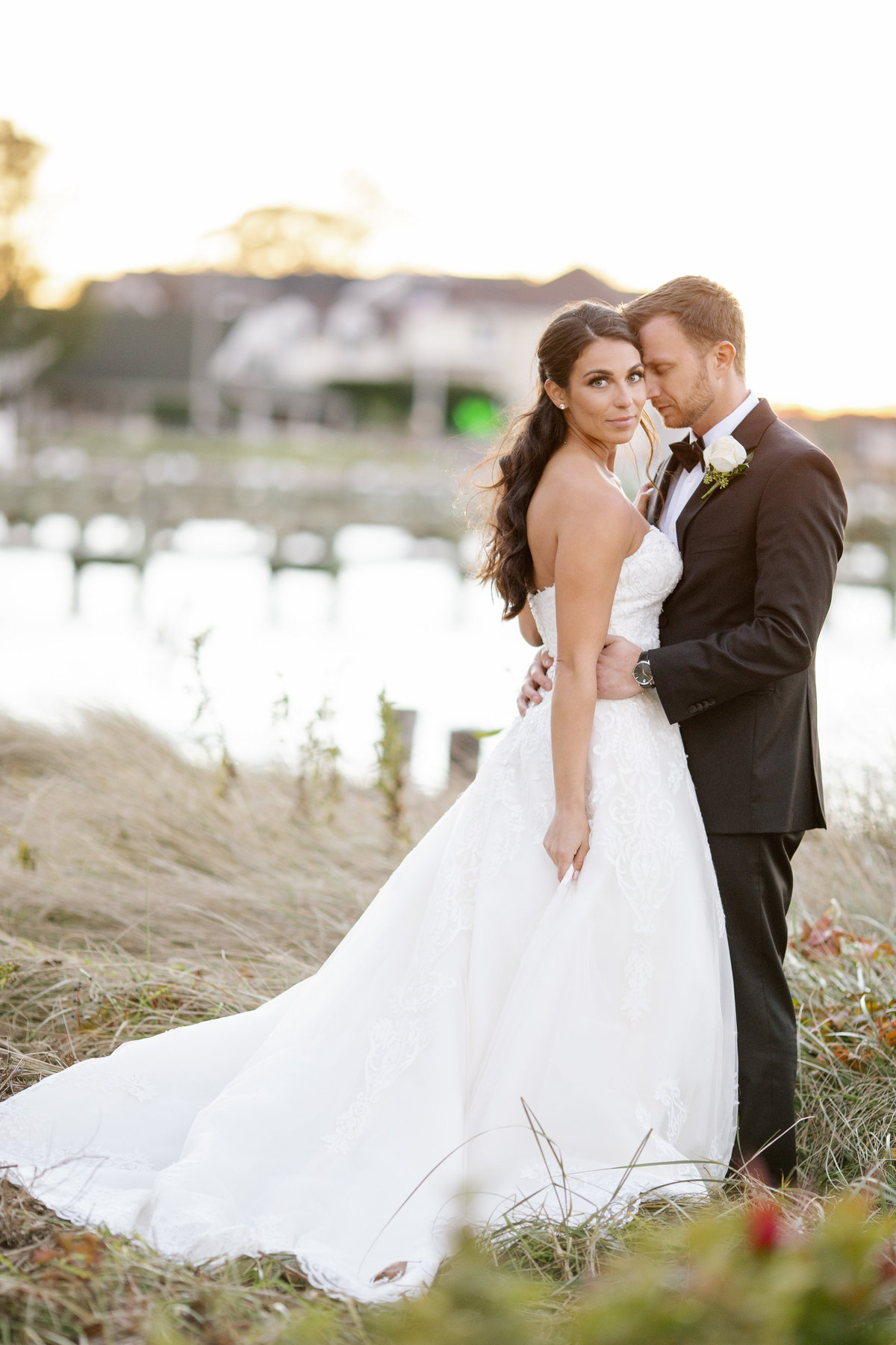 bride and groom by dock at clarks landing yacht club wedding