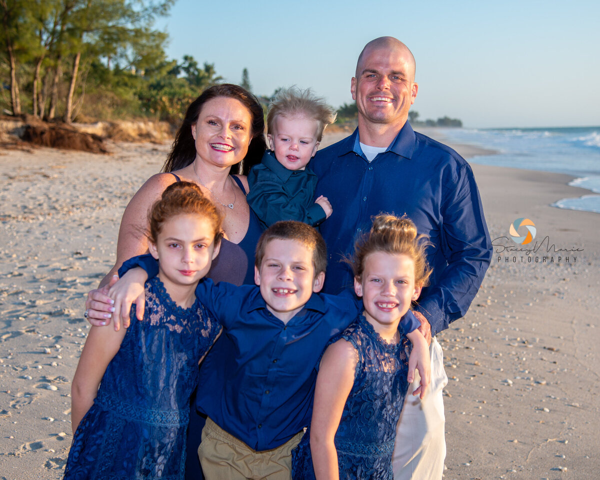 A blended family poses for family photos on Casey Key