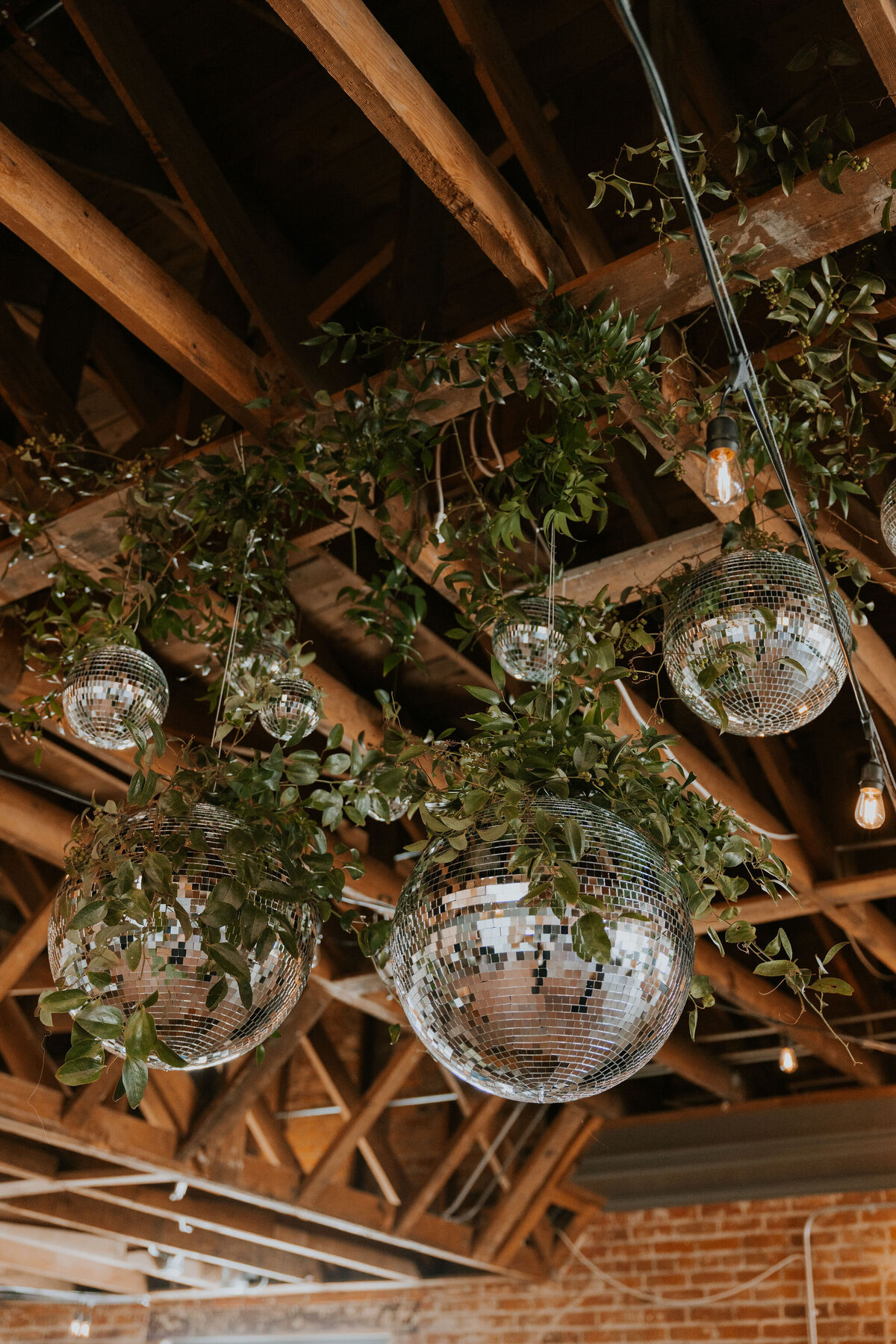 Greenery and white wedding hanging bulb lights  at The St Vrain, wedding venue