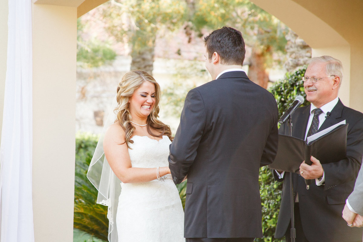 Photo of bride and groom exchanging vows at their outdoor wedding ceremony | Susie Moreno Photography