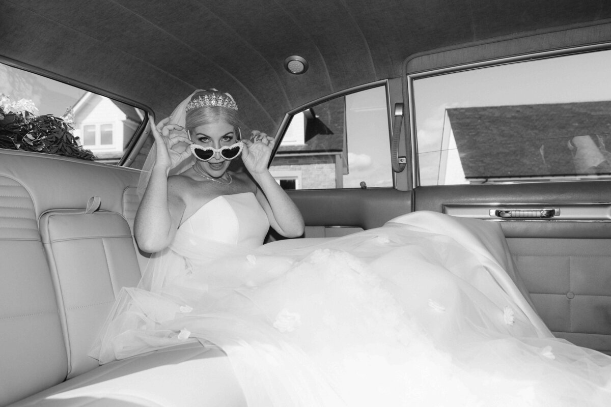 A bride in a cadillac with sunglasses