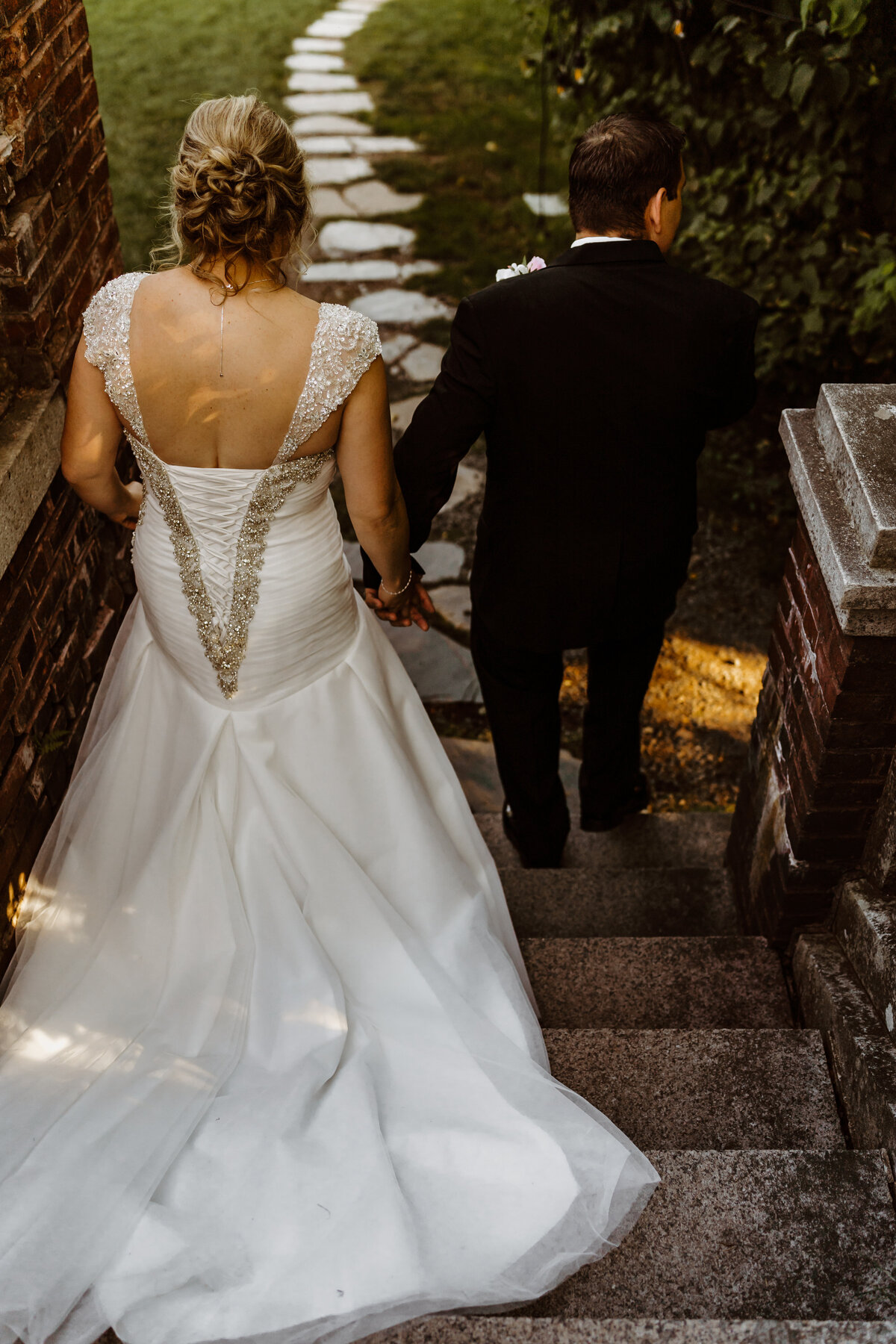 married couple walking down the steps at the Glensheen Mansion in Duluth Minnesota