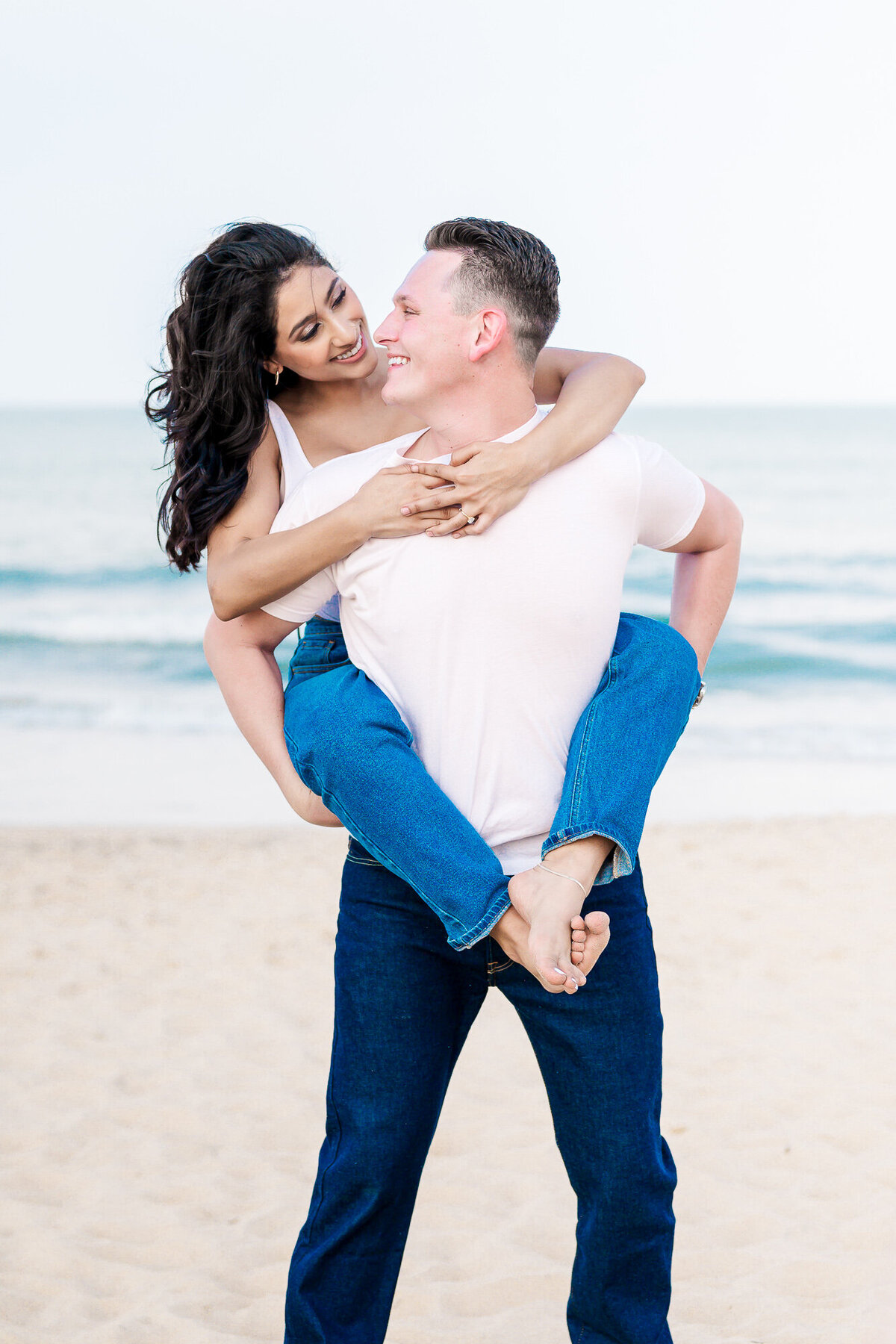 An engaged couple on the beaches of Wilmington  in the springtime by JoLynn Photography, a North Carolina wedding photographer