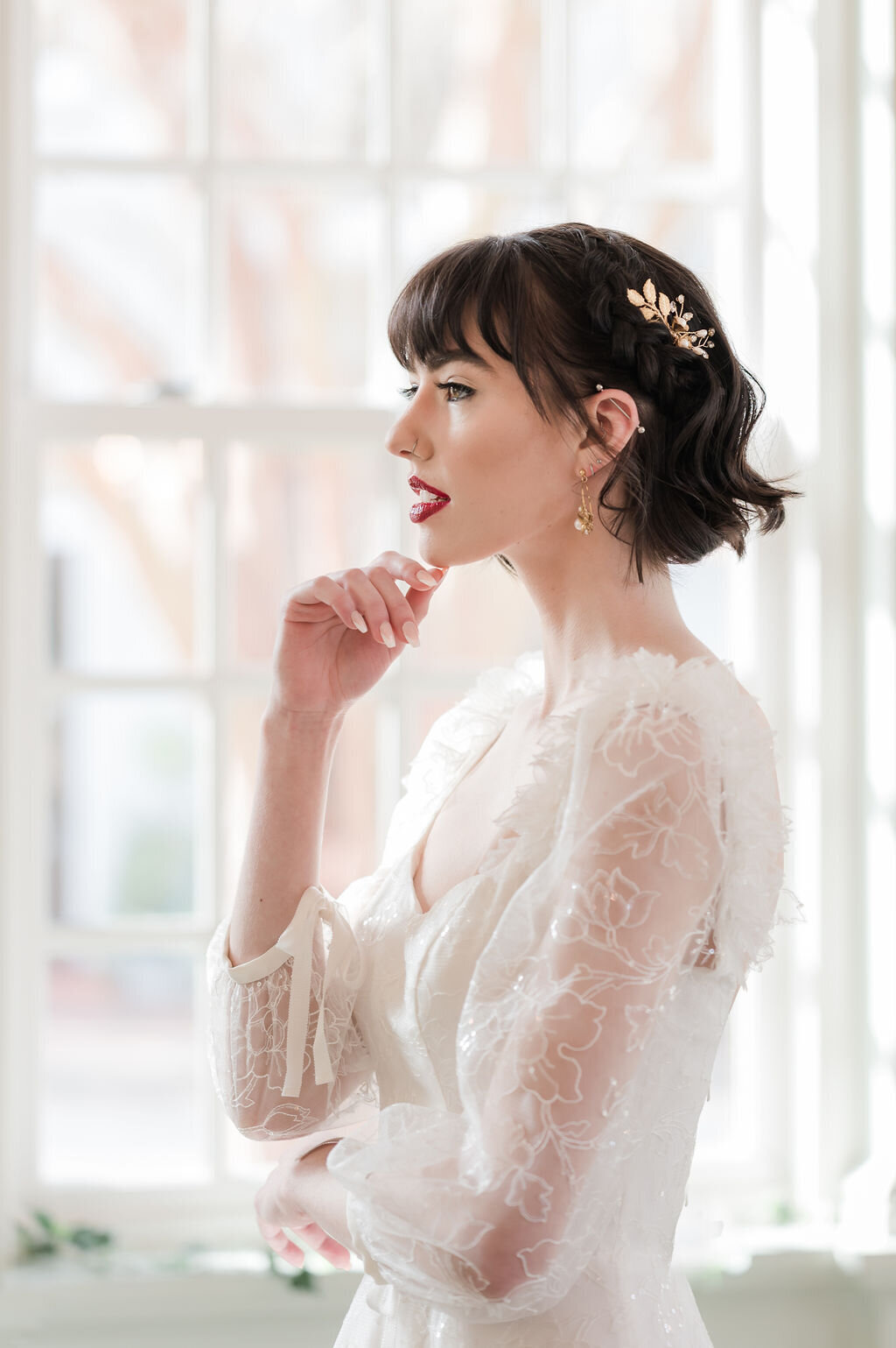 Sparkly sheer lace three-quarter sleeves and 3D flower shoulder details on the Gene wedding dress style by Edith Elan.