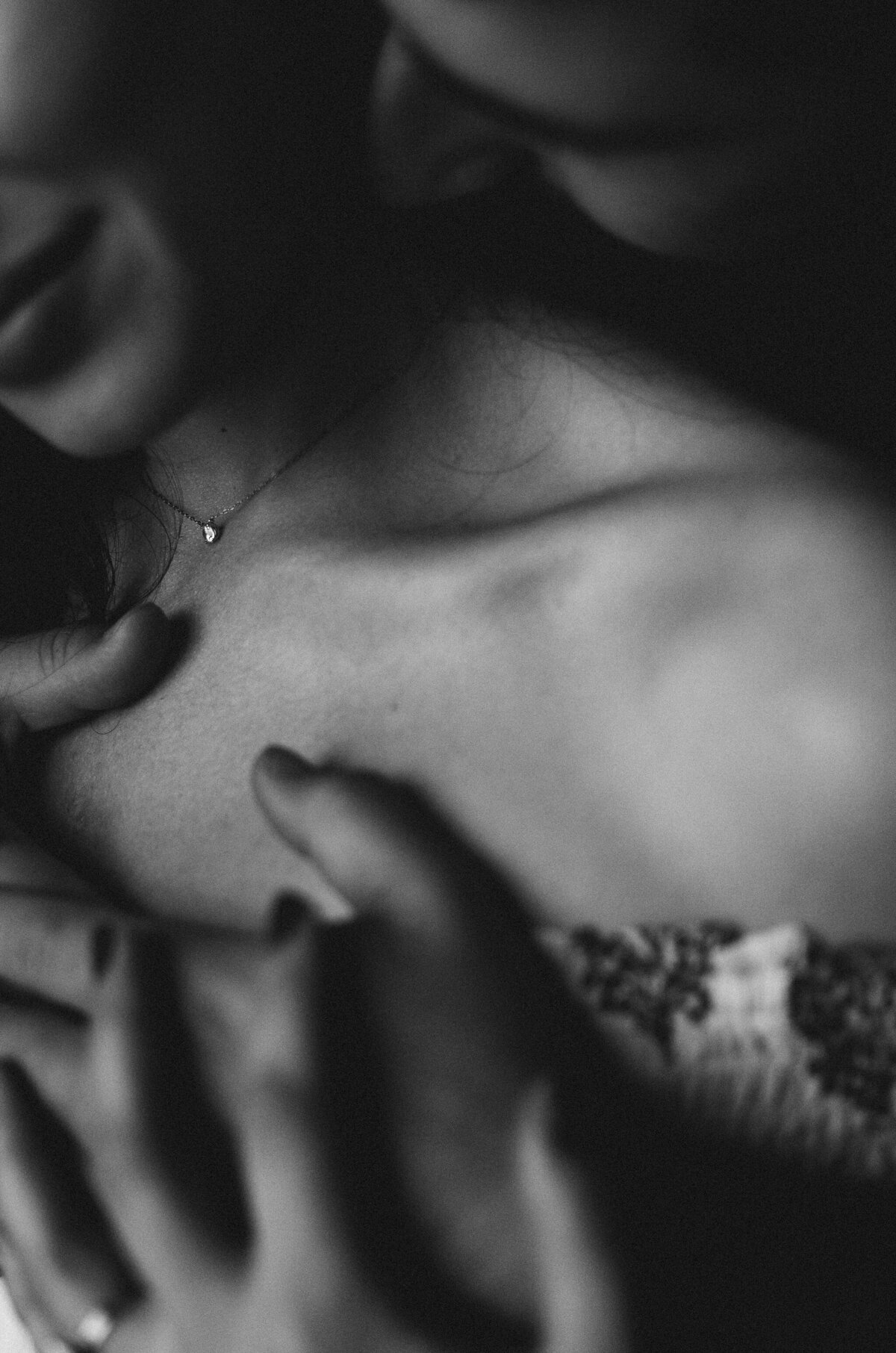 black and white moody intimate portrait of couple embracing