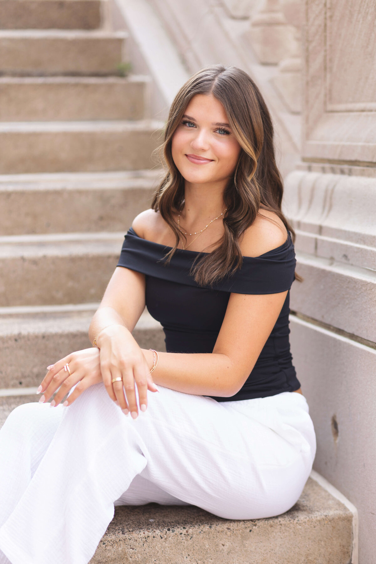 girl in black shirt sitting on steps