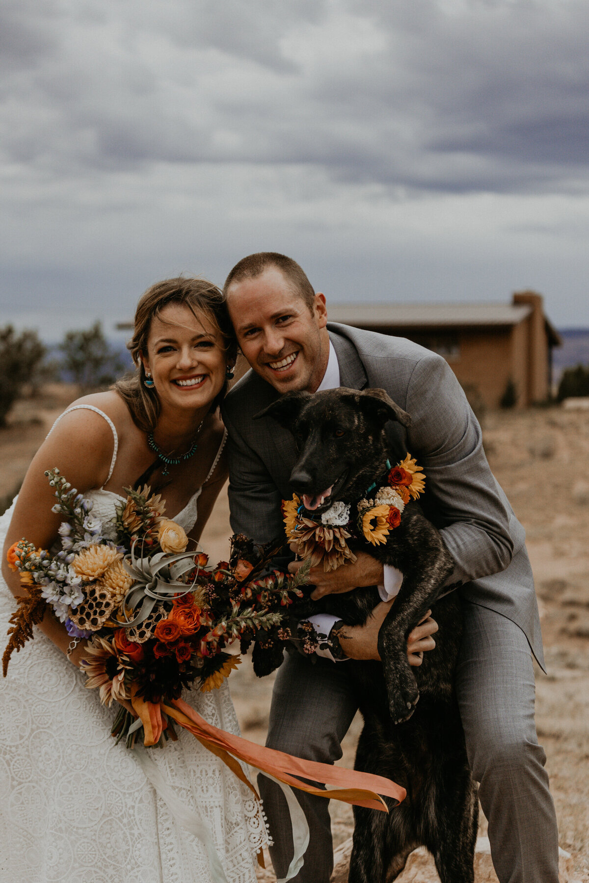 bride and groom with dog after ceremony