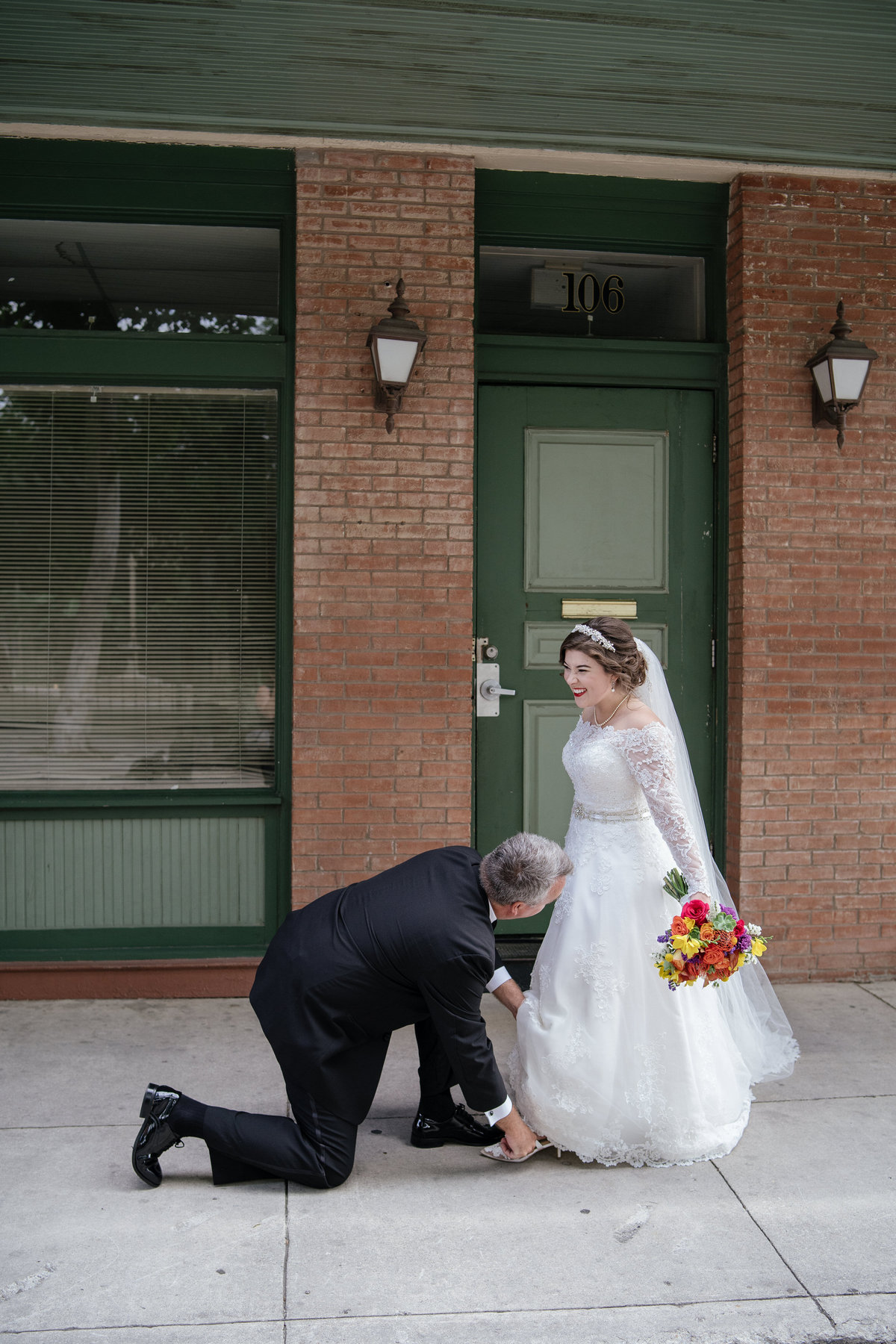 Father of bride putting a sixpence in brides shoe just before wedding ceremony at The Spire venue in downtown San Antonio
