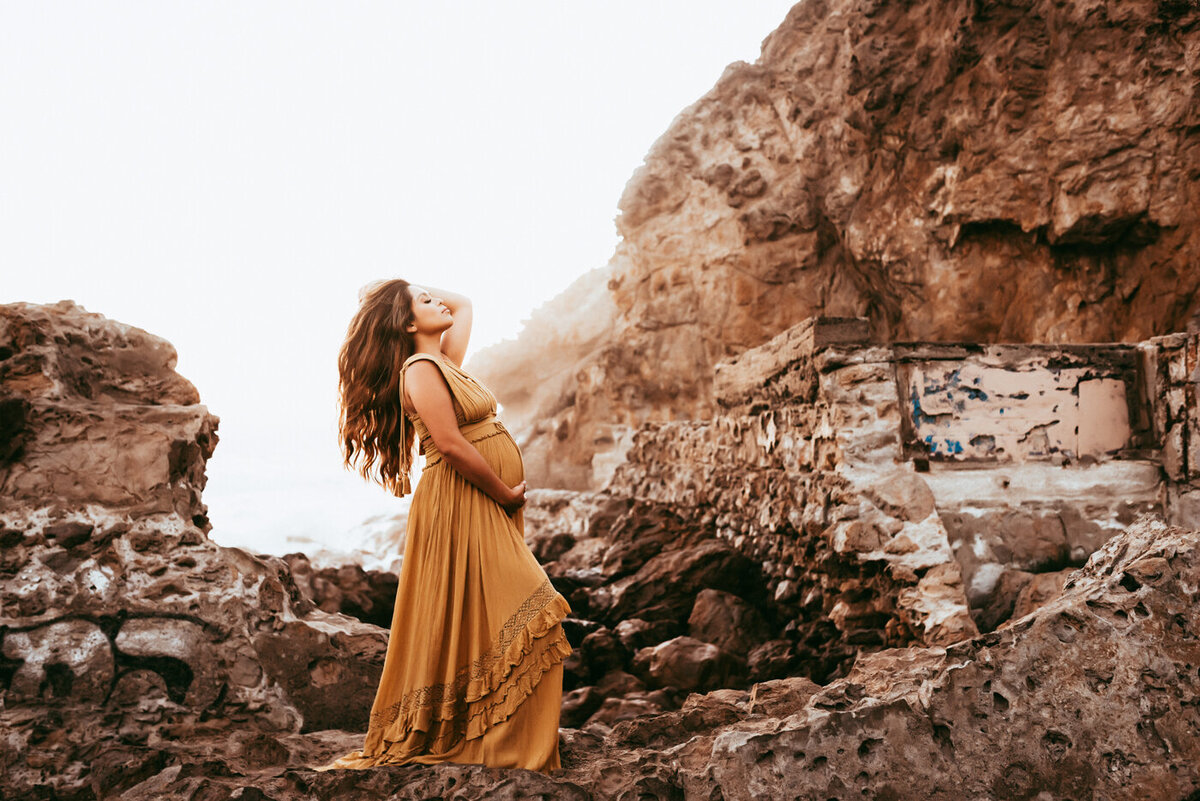Maternity session with mama wearing mustard colored gown in San Francisco