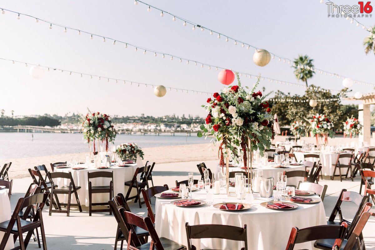 A Newport Dunes wedding reception table setup just off the sands and ocean waters