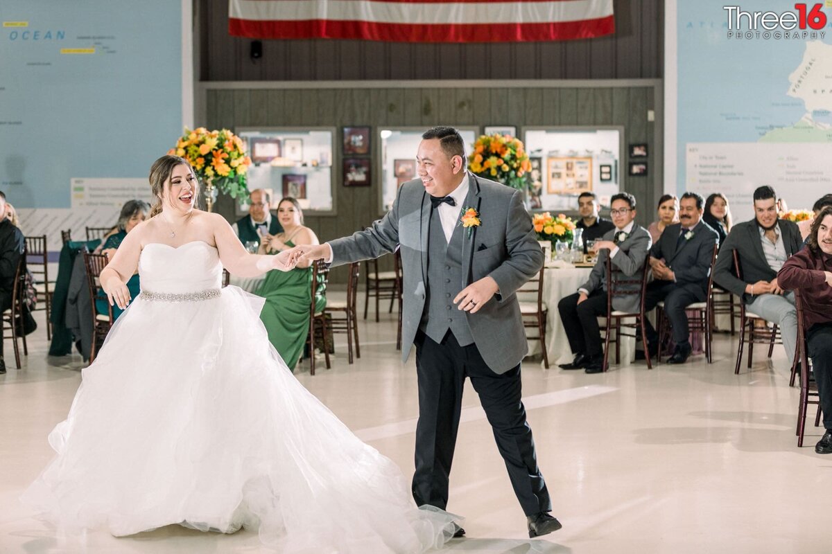Groom spins his Bride on the dancefloor during their first dance