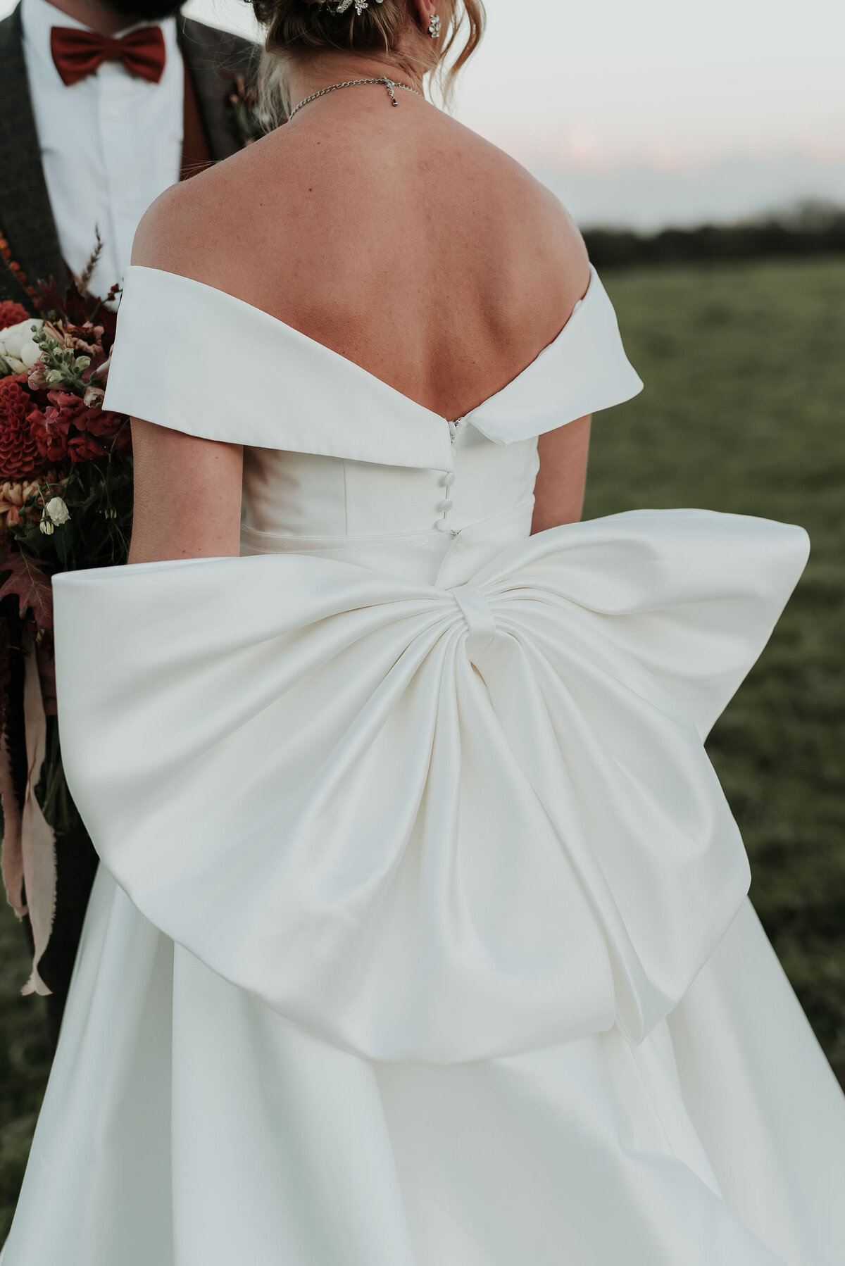 Close up of a stunning white bridal gown with elegant giant bow
