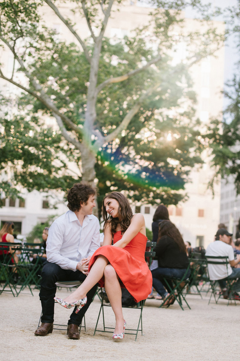 Happy Couple in Bryant Park in NY during their summer engagement session