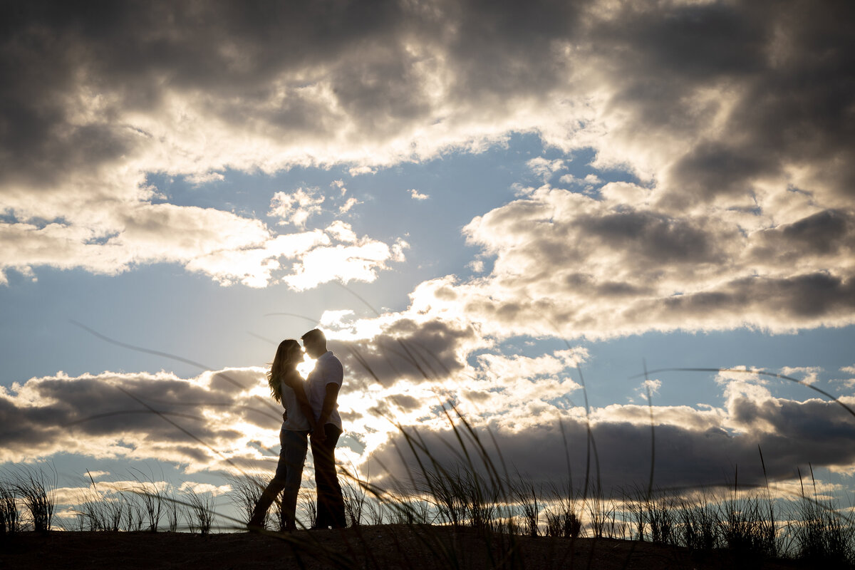 engagement-silhouette-sunlight-clouds-sandy-hook-beach