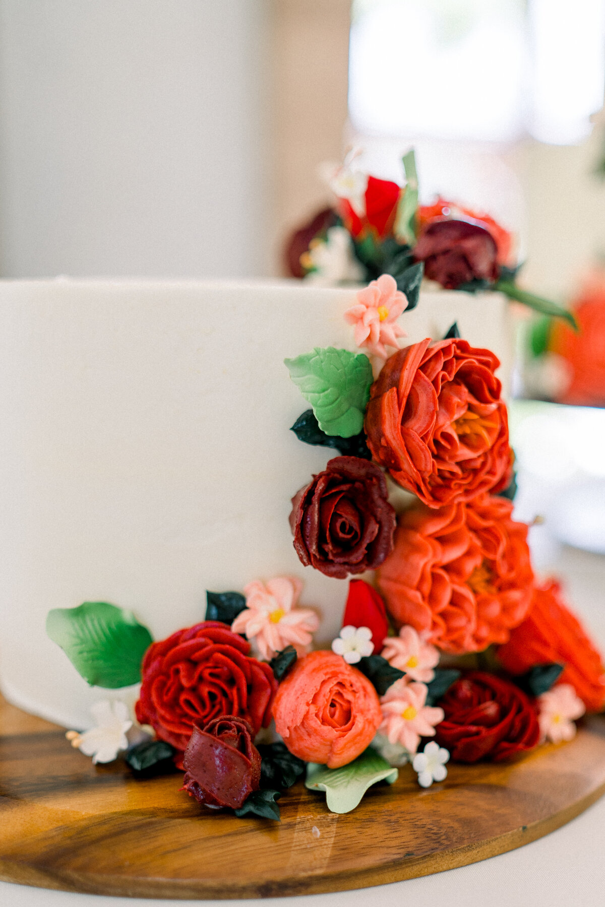 Wedding cake with red flowers at Vizcaya Sacramento, CA